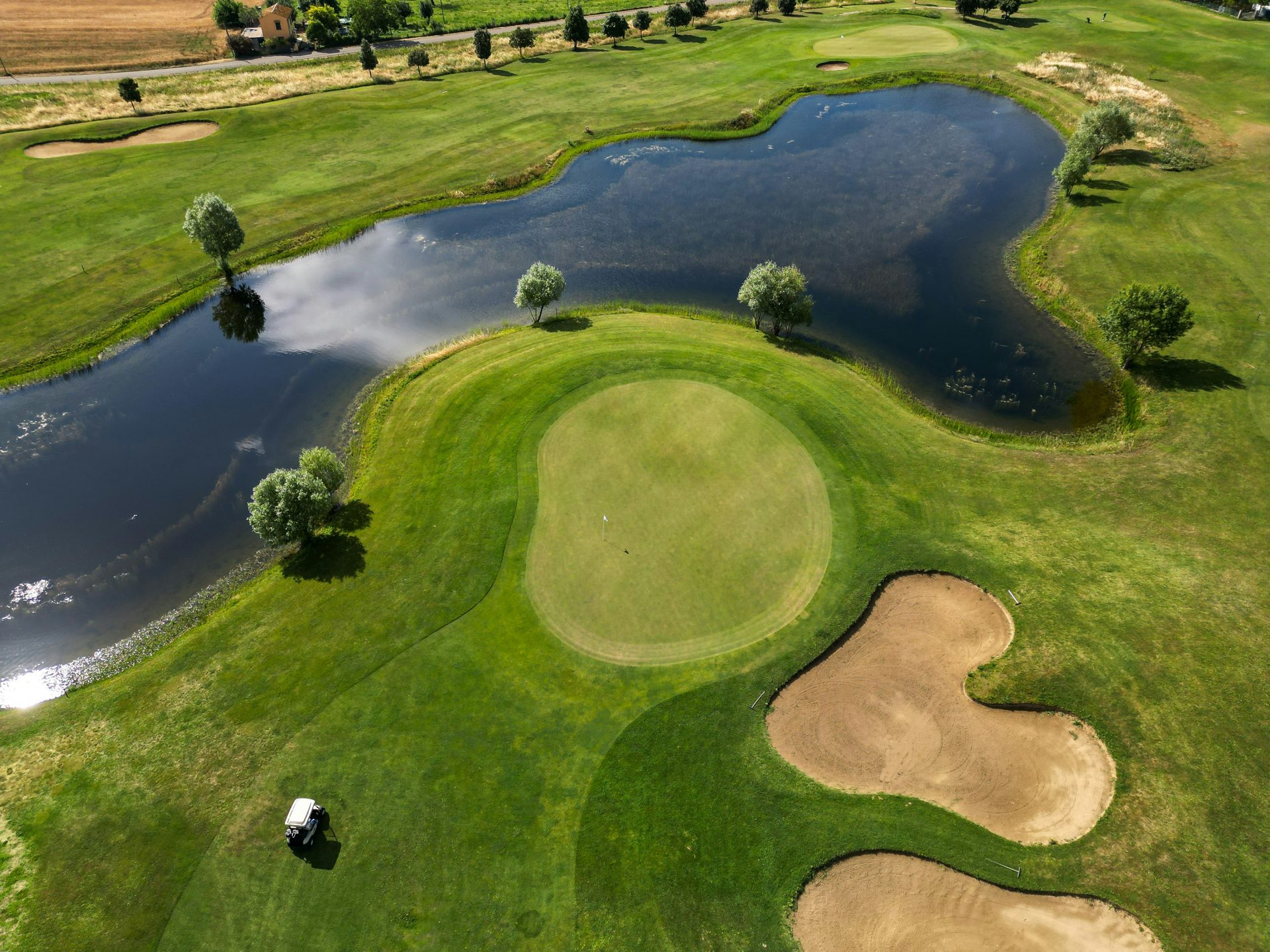 Aerial of an Oak Crest green beside a pond in the Upper Peninsula